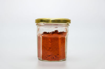 Close-up of glass of jar against white background