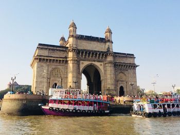 View of boats in sea gateway to india against sky