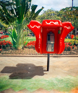 Red fire hydrant against trees