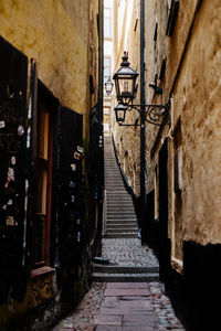 Rear view of woman walking on street amidst buildings