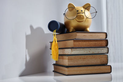 Stack of books on table against wall