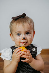 Halloween thanksgiving makeup ideas for kids and baby. happy funny baby with a pumpkin on home 