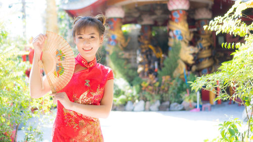 Portrait of smiling girl holding outdoors