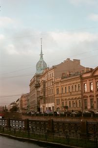 Buildings in city against sky during sunset