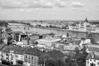 High angle view of river by buildings against sky