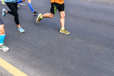 Low section of people running on road