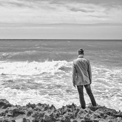 Rear view of man standing on beach