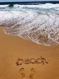 High angle view of text on beach