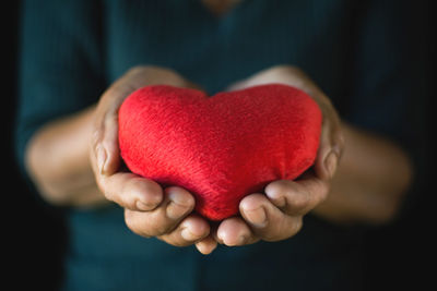 Close-up of hand holding heart shape