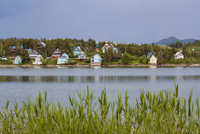 Scenic view of lake by building against sky