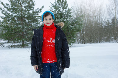 Portrait of cute teenage boy in a winter park