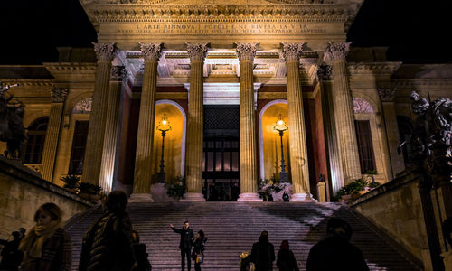 Group of people in illuminated building at night