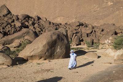 Man walking on dirt road in sunny day