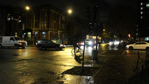 Cars on city street during rainy season at night