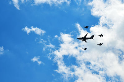 Low angle view of airshow against sky