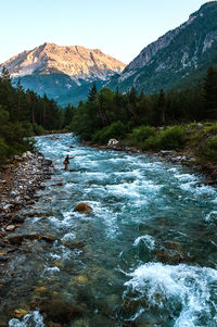 Scenic view of river and mountains