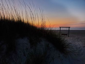 Scenic view of beach against sky during sunset