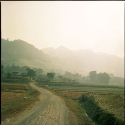 Scenic view of landscape against sky during foggy weather