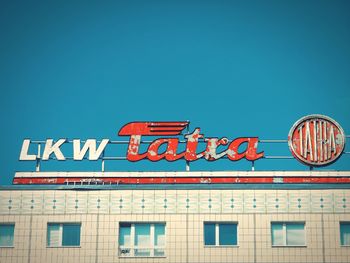 Low angle view of information sign against clear sky