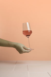 Cropped hand holding drink