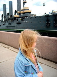 Girl in city against sky