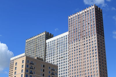  view of modern buildings against blue sky.