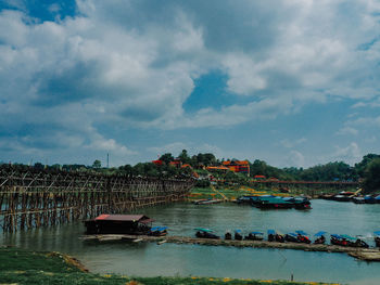 Boats moored in river against sky