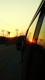 Car on road against sky during sunset