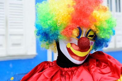 A person dressed up in venice carnival style has fun during the street carnival 