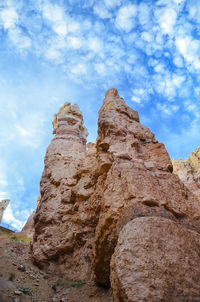 Low angle view of rock formation against sky