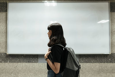 Rear view of woman looking at camera