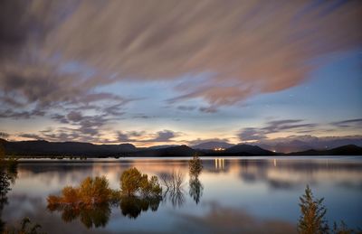 Scenic view of lake against sky during sunset
