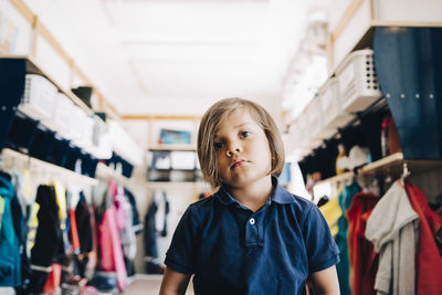 Boy sitting in cloakroom at kindergarten