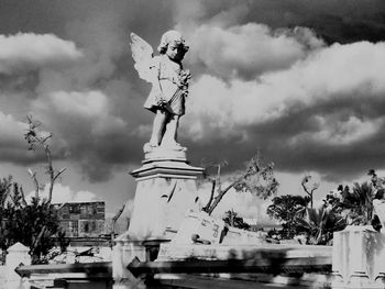 Low angle view of statue against cloudy sky