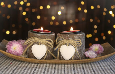 Close-up of illuminated candles on table