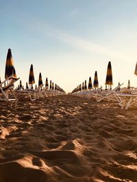 Group of people on beach against clear sky