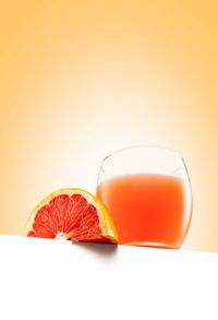 Close-up of orange juice on table