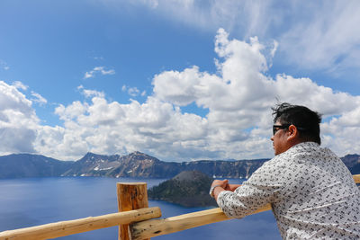 Man looking at sea against sky