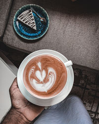 Cropped image of hand holding coffee cup