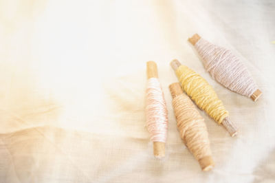The pastel color embroidery thread roll using in the garment industry put on the white background.