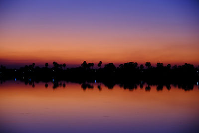 Scenic view of lake against romantic sky at sunset