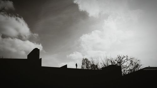 Low angle view of built structure against cloudy sky