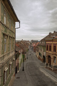 Street amidst buildings against sky in city