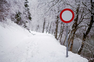 Road sign on snow covered field