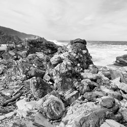 Rocks on beach against sky