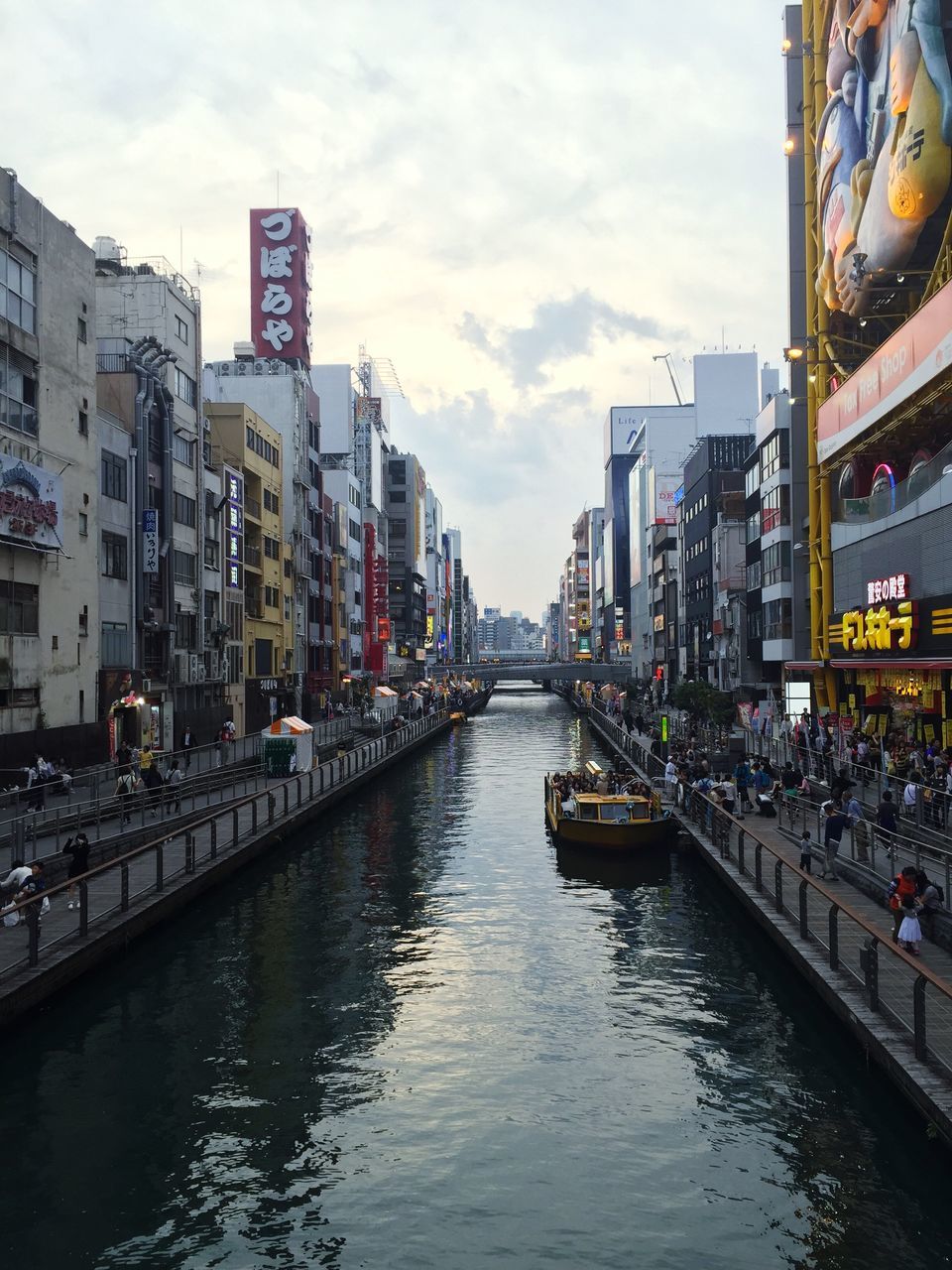 architecture, built structure, building exterior, water, canal, waterfront, city, sky, transportation, river, diminishing perspective, city life, incidental people, building, residential building, residential structure, day, mode of transport, outdoors, nautical vessel