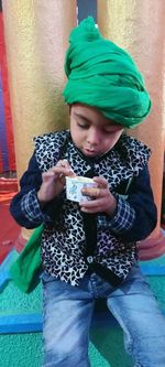 Full length of boy holding mobile phone