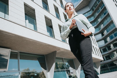 Low angle view of man standing against building