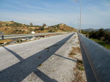 Road by street against sky