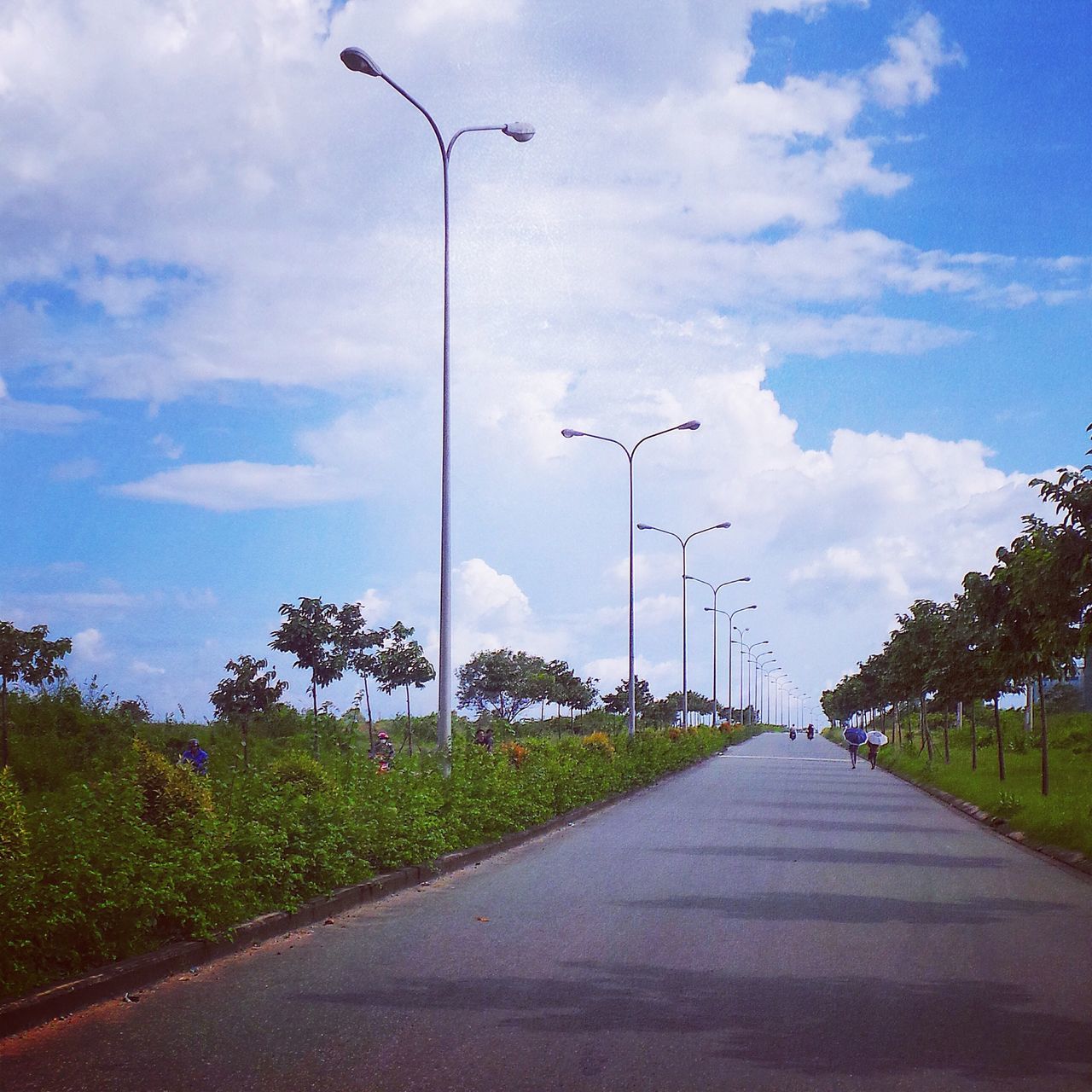 the way forward, sky, street light, road, cloud - sky, diminishing perspective, street, transportation, tree, vanishing point, cloudy, cloud, road marking, empty, lighting equipment, empty road, outdoors, day, blue, asphalt